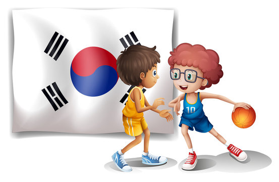 Two boys playing basketball in front of the Korean flag