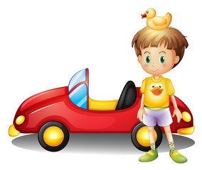 A young boy with a rubber duck and a big toy car