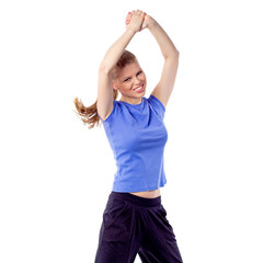 Cheerful happy woman dancing zumba dance with arms raised