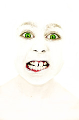 Little girl with painted face who grinds her teeth