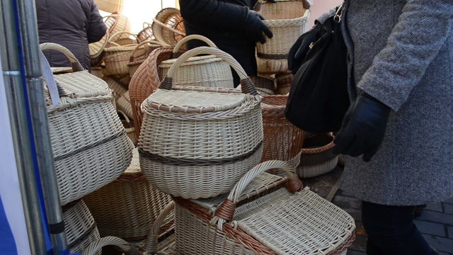 woman at the market choosing wicker basket picnic in the summer