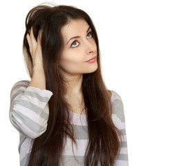 Thinking woman holding hair and looking up. Closeup portrait iso