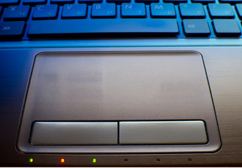 close up of laptop keyboard as a background toned to blue