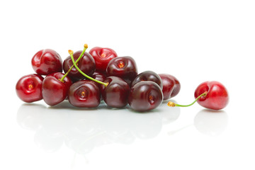 bunch of ripe cherries on a white background with reflection