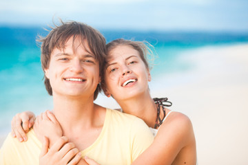 portrait of young happy couple having fun on tropical beach.