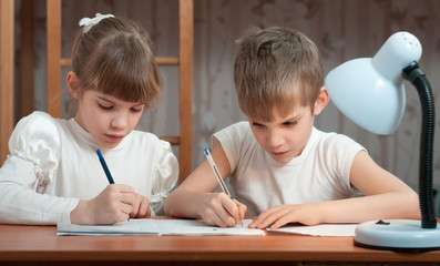 children draw in a notebook