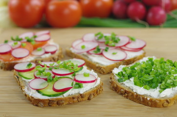 four slices of bread with cottage cheese and the vegetables