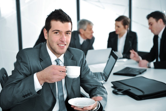 Businessman in business ambience drinking cofee