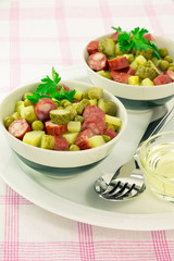 Salad with peas, smoked sausage and pickle served for two