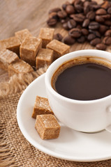 Cubes brown sugar and cup of coffee