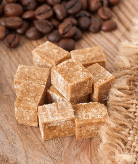 Close up of brown sugar cubes and coffee beans