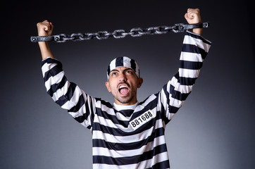 Convict criminal in striped uniform