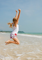 flying jump beach girl on blue sea shore in summer vacation