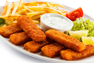 Fried fish fingers, French fries and vegetables