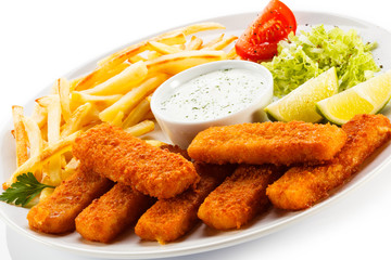 Fried fish fingers, French fries and vegetables