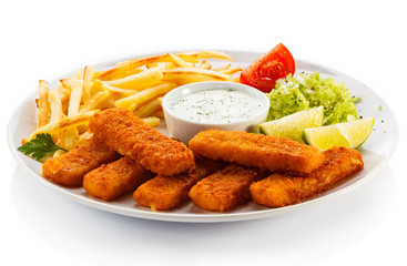 Fried fish fingers, French fries and vegetables