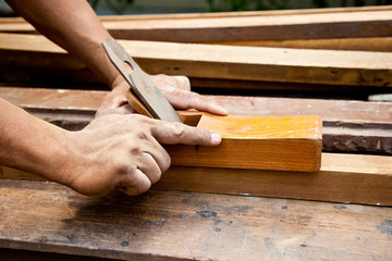 Carpenter's working on a piece of wood.