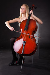 Beautiful young woman playing cello