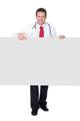 Confident doctor presenting empty banner