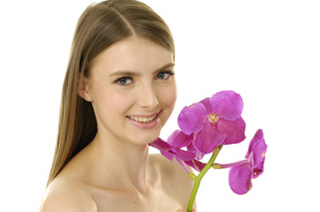 Young woman with beautiful makeup and pink orchids.