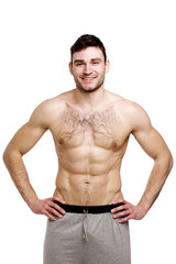 Obraz premium Topless man stood with his hands on his hips
