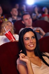 Beautiful girl in cinema smiling