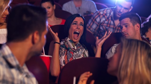Young woman screaming at cinema