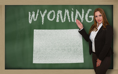 Teacher showing map of wyoming on blackboard