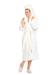 Full length portrait of smiling young woman in bathrobe