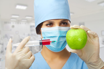 Doctor with syringe and apple