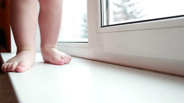 Baby legs. First steps. Slow motion.
