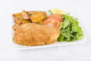 Wiener Schnitzel - Breaded fried veal, potato wedges and salad.