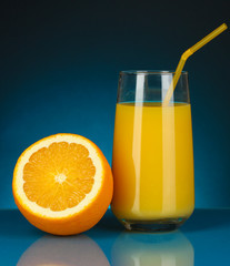 Delicious orange juice in glass and orange next to it