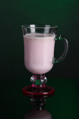 Cream cocktails on dark green background