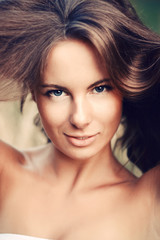 Fototapeta premium Сloseup portrait of young woman with beautiful hair