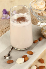 Glass of chocolate-cream cocktail on wooden table close-up