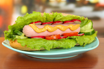 Tasty hot dog on table in cafe