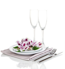 Festive table setting with flowers isolated on white