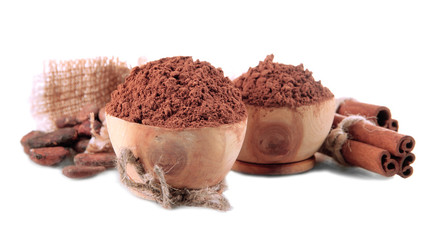 Cocoa powder in wooden bowls and spices, isolated on white