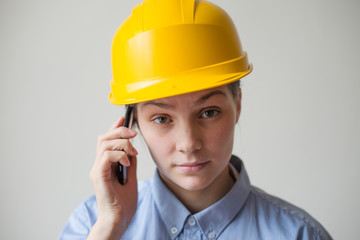 A woman in a helmet with a mobile phone