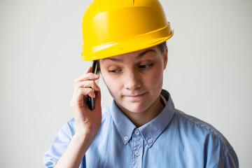 A woman in a helmet with a mobile phone