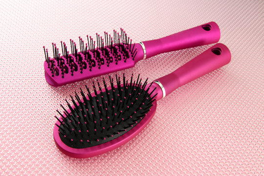 Comb brushes on pink background