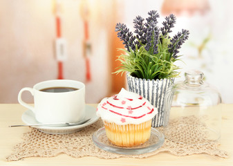 Cupcake on saucer with glass cover, on bright background