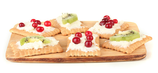 Tasty canapes with cheese, kiwi and cranberry,