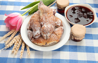 Taste croissants and jam, on tablecloth.