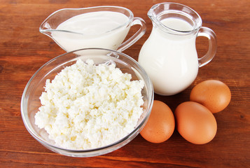 Dairy products and eggs on wooden background