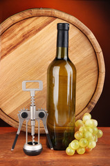 Composition of corkscrew and bottle of wine, grape, wooden