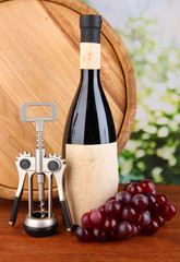Composition of corkscrew and bottle of wine, grape, wooden