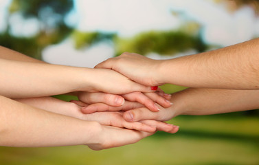 Many hands on nature background