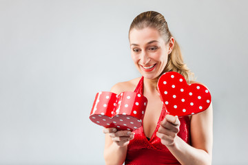 Woman opening the gift and is happy